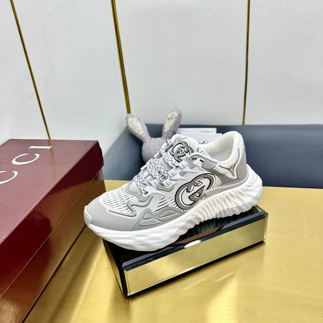 出厂价Pp #古驰系列运动鞋采用创新缝线工艺制作，打造如水般的流 动质感。皮革设计搭配三维立体互扣式双G皮革贴饰和Gucci字母 金属配件，以3D效果成就整款鞋