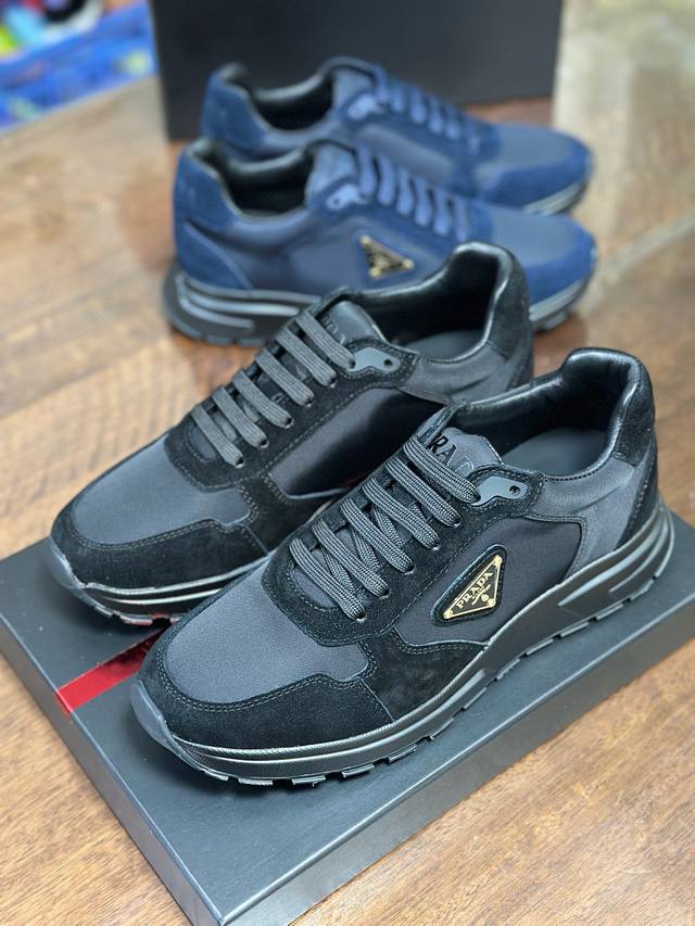 2Ee436 这款运动鞋以Re-Nylon与绒面牛皮革鞋面呈现混搭风动感廓形，搭配舒适的鞋底。重新诠释经典款型Prax，饰以Pra＊＊徽标。 带徽标鞋带 鞋面饰