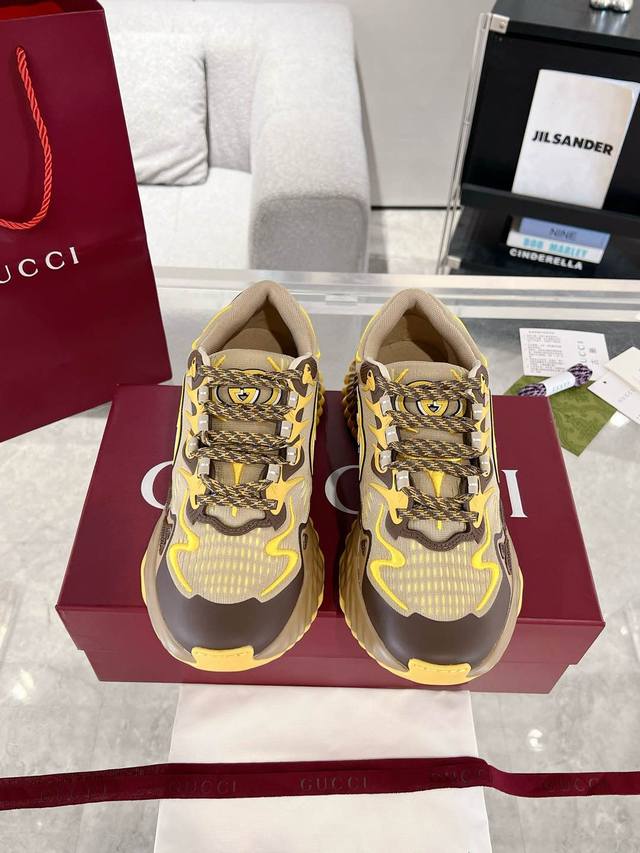 Gucci Ripple系列情侣款运动鞋 这款全新运动鞋采用厚底设计，配以缝线皮革鞋面与透气网布，展现十足科技感。3D效果互扣式双G皮革贴饰和Gucci字母标识