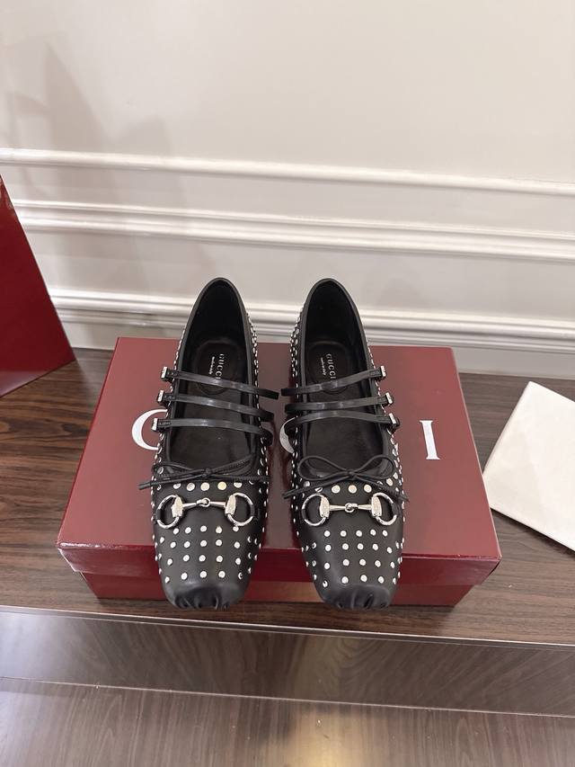 Gucci Horsebit系列女士柳钉芭蕾平底鞋 这款标志性的马衔扣芭蕾平底鞋选用方形鞋头设计，搭配雅致的蝴蝶结细节，致敬传统芭蕾舞鞋款型。这件单品以古驰安可