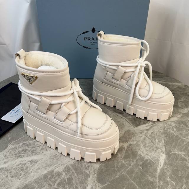 P家最新款，顶级版本。 面：进口超软牛皮、高丝光牛反绒 里：皮毛一体纯真羊毛 垫：纯羊毛 底：防滑花纹橡胶底 厚4.5Cm 标志性三角标，原版包装 Size:3