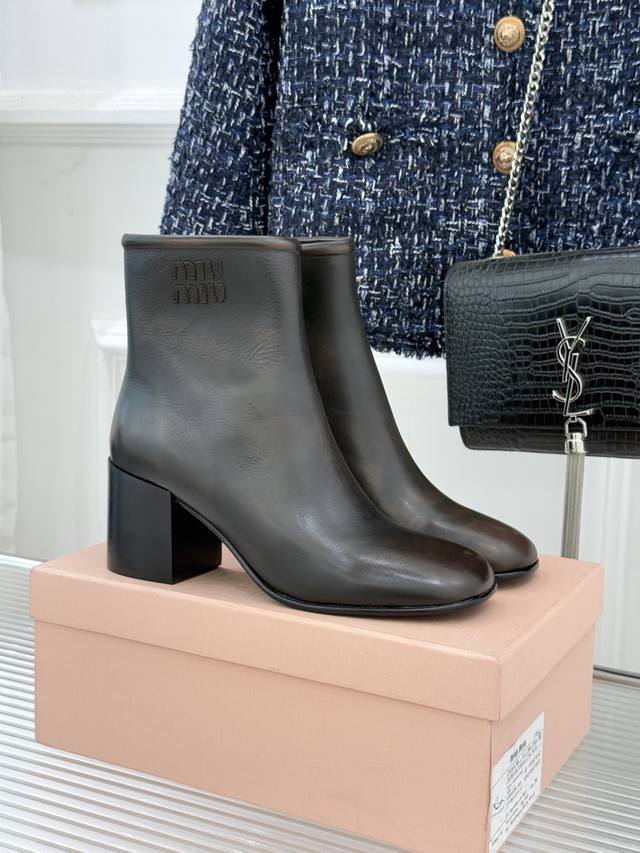 厂价 Miu Miu25Wf新品字母复古粗跟短靴 当复古肌理碰撞现代锋芒 这款跟短靴携时代韵味而来 为当代女性的多元风格写下注脚。 柔润复古方头勾勒脚型轮廓 不